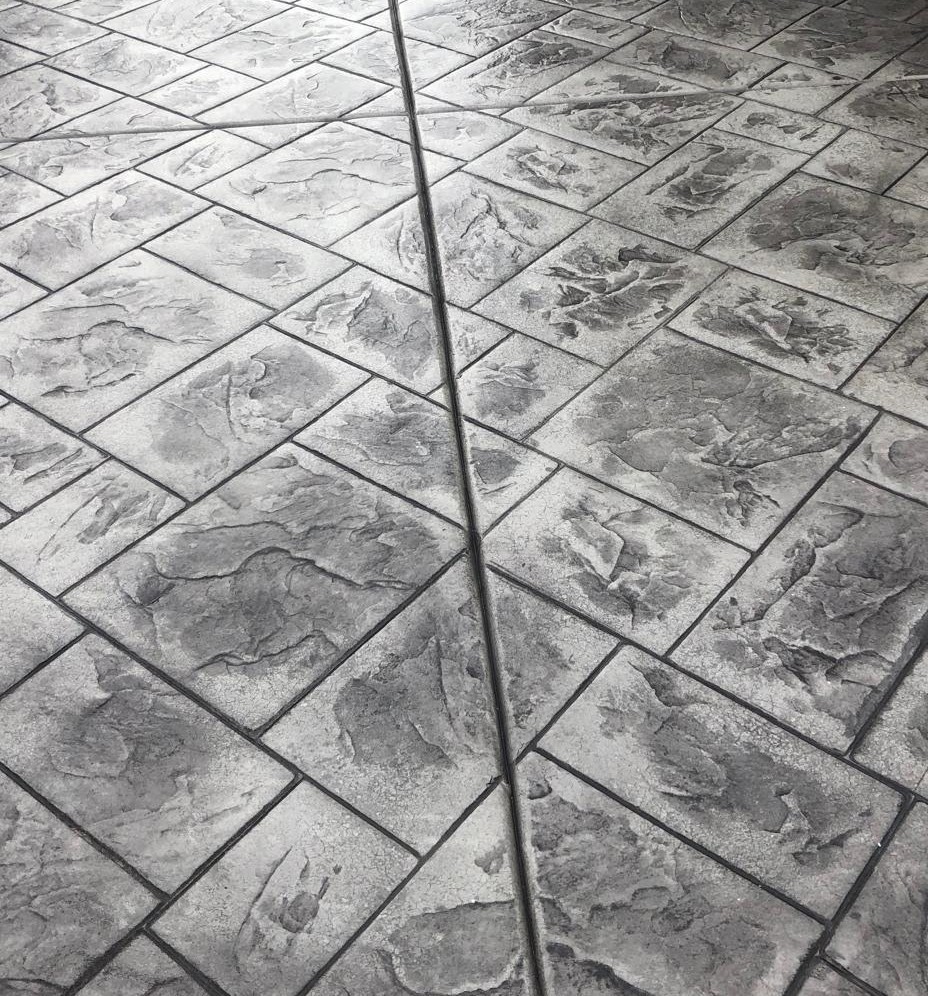 Charcoal stamped concrete with a glossy sealed finish
